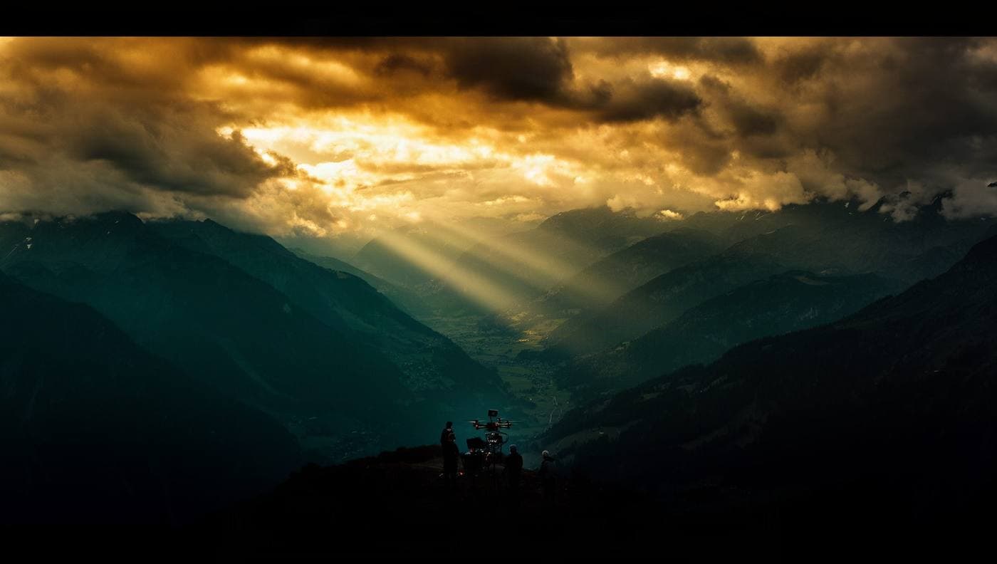 A NordCierge production crew filming an alpine valley at golden hour